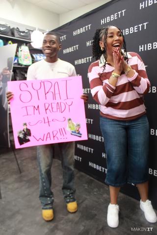 Sy’Rai reacts as a fan holds a handmade “I’m Ready 4 War” sign at the Cold War EP release event