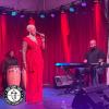 Philippe Bonhomme sits in front of a keyboard with guest musicians by his side.